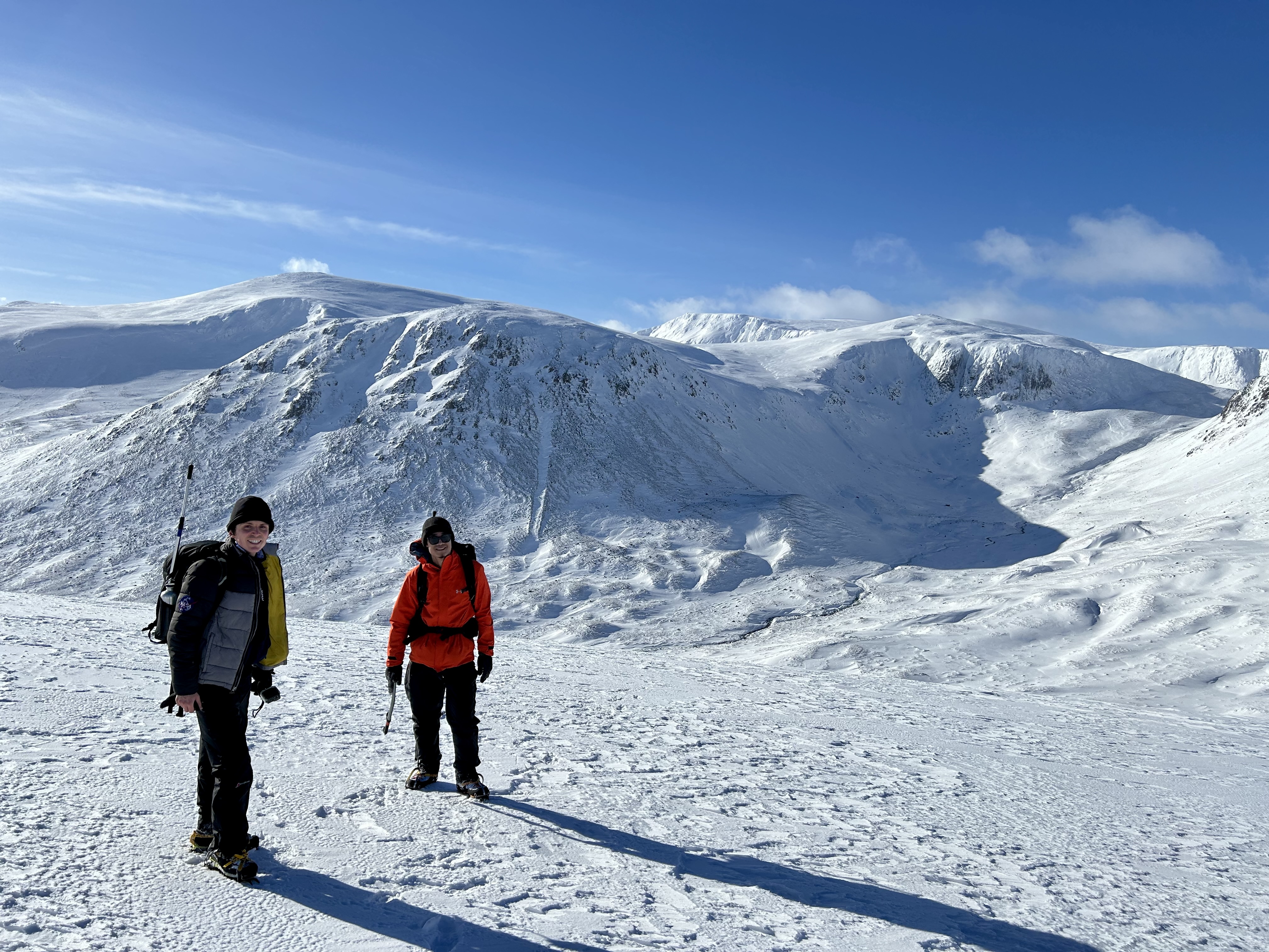 Two astronomers during a winter ascent of Beinn a' Chaorainn, Scotland
